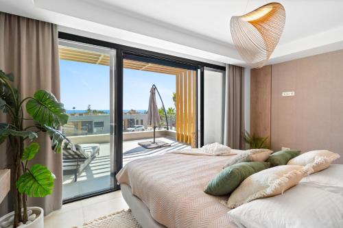 a bedroom with a bed with a view of a balcony at Evergreen Exclusive in Mijas Costa