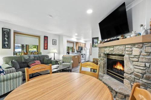 a living room with a couch and a fireplace at Hilltop Hideaway Unit B-5 by Simple Life Rentals in Fish Creek
