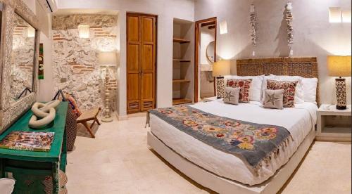 a bedroom with a large bed and a green table at IsaLuna Luxury House in Estación El Salto