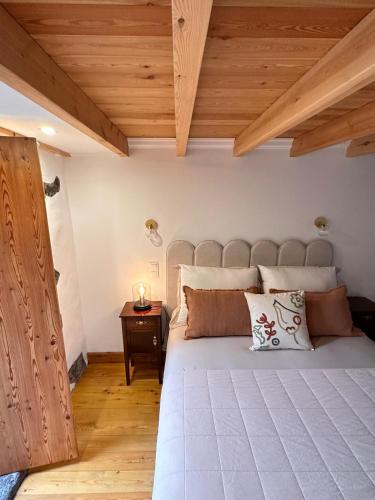 a bedroom with a large bed and a wooden ceiling at Ferreiro do Cabeço House in Bandeiras