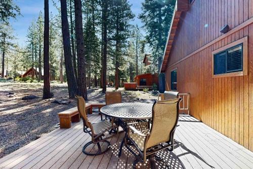 a patio with a table and chairs on a wooden deck at Schussing Escape in Truckee