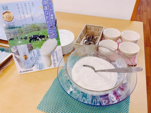a table with a bowl of food and a package of milk at Smile Hotel Sendai Tagajyo - Vacation STAY 05403v in Tagajo