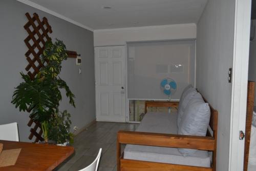 a living room with a couch and a table at De Triana Hotel in Rancagua