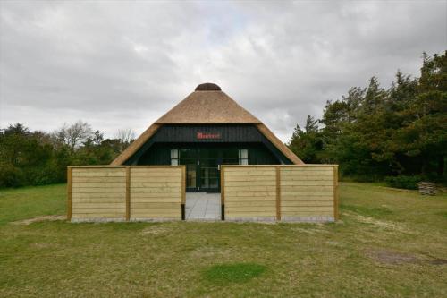 a large building with a thatched roof and two gates at 20356-Ulfborg-Lars-Murersvej-9 in Vedersø Klit