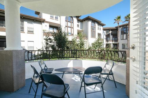 a patio with a table and chairs on a balcony at Multiple Miracle Mile Apartments Hub in Los Angeles