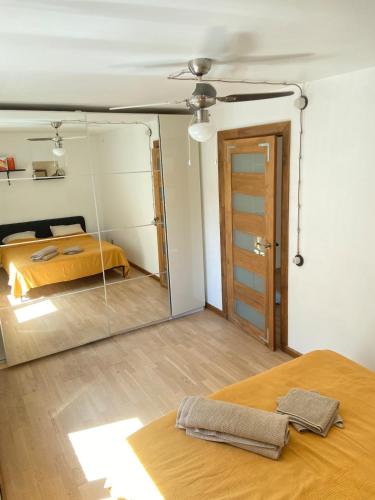 a bedroom with a mirror and a bed in it at Lelle Stay in Kuldīga