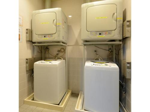 a bathroom with two machines in a room at Smile Hotel Sakurambo Higashine - Vacation STAY 92782v in Higashine