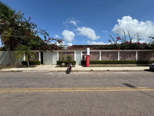 a motorcycle parked in front of a white building at PORTO PLAZA POUSADA in Barcarena