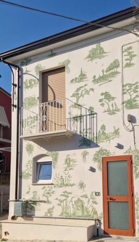 a mural on the side of a building with a balcony at CB Apartments in Bonito