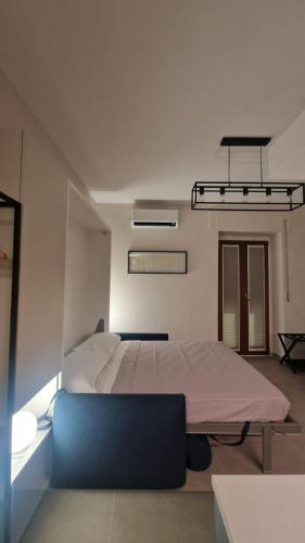 a bedroom with a large bed and a blue couch at CB Apartments in Bonito