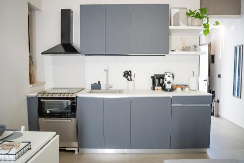 a kitchen with blue cabinets and a sink at CB Apartments in Bonito