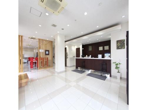 a large living room with a white tile floor at Smile Hotel Sakurambo Higashine - Vacation STAY 92767v in Higashine