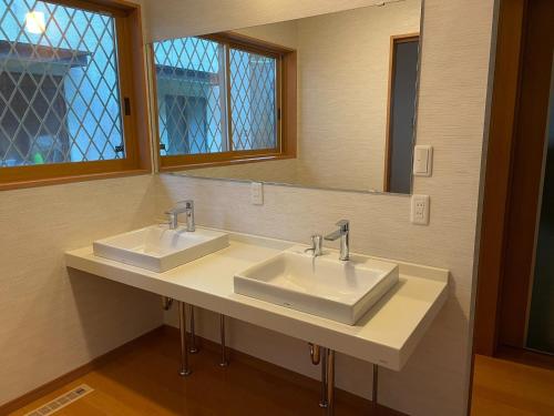 a bathroom with two sinks and a mirror at Hanano wa - Vacation STAY 96015v in Nikko