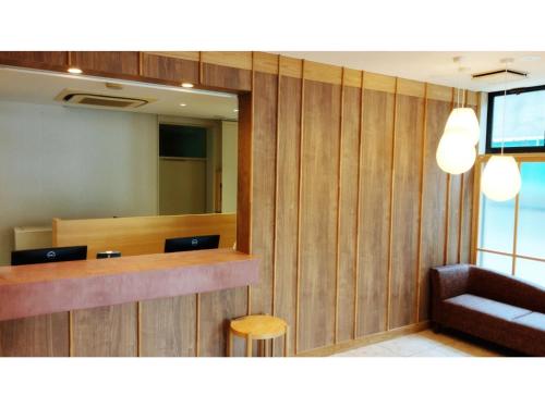 a waiting room with a mirror and a chair at DIG the Osaka - Vacation STAY 14513v in Suita