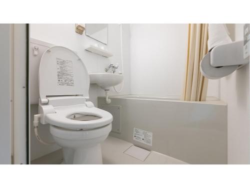 a white bathroom with a toilet and a bath tub at DIG the Osaka - Vacation STAY 14513v in Suita
