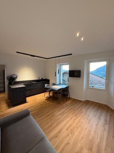 a living room with a couch and a table at DN ART ROYALE - APT N vasca idromassaggio interno piano terra -APT D esclusivo terrazzo esterno con jacuzzi in Blevio