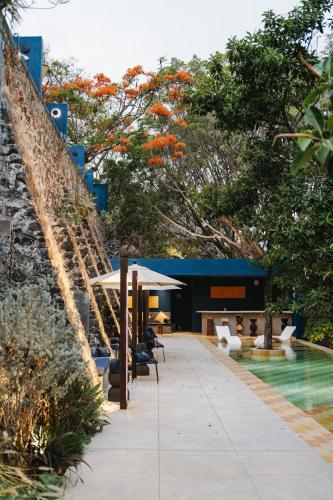 a resort with a swimming pool next to a building at Casa Cristina Fresh Boutique Hotel in Cuernavaca