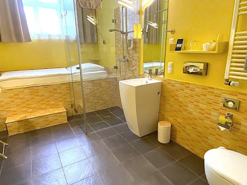 a bathroom with a shower and a sink and a toilet at Hotel 38 in Berlin
