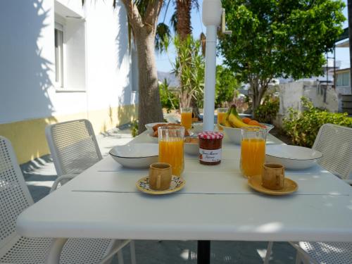 a white table with food and drinks on it at Casa Kamara in Kardamaina