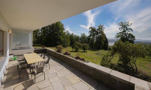 a patio with a table and chairs and a view at Vilas & Wellness Resort Orlík in KozÃ¡rovice