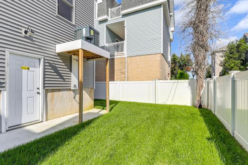 a house with a white fence and a yard at Walk to Beach and Moreys Piers Family Getaway! in Wildwood