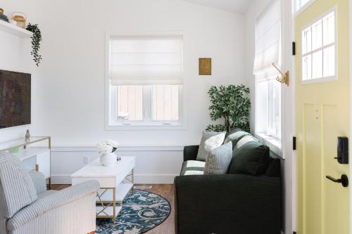 a living room with a couch and a table at Brass Apple Cottage in Campbell River