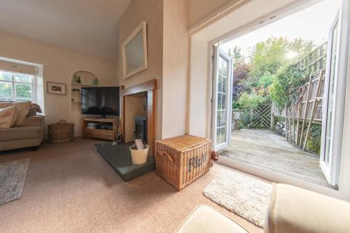 a living room with a large window and a couch at Meadowcroft in Lindale