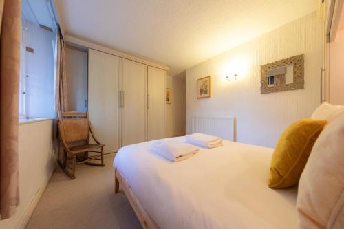 a bedroom with a white bed and a window at Meadowcroft in Lindale
