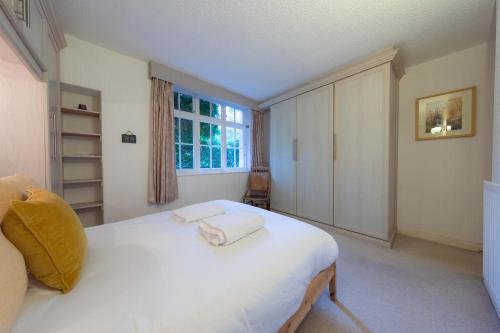 a bedroom with a white bed with two towels on it at Meadowcroft in Lindale