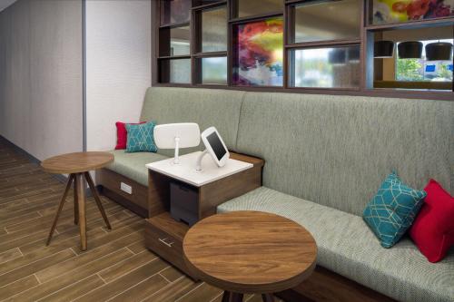 a waiting room with a couch and a table at Hampton Inn Kissimmee North in Kissimmee