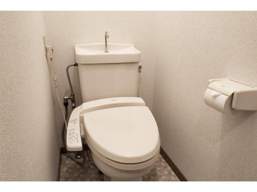 a bathroom with a white toilet with a sink at Hotel Pacific - Vacation STAY 07373v in Ishinomaki