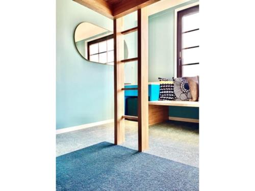 a dressing room with a mirror and a blue wall at K,M,H Art hotel by Kure Morisawa - Vacation STAY 23309v in Kure