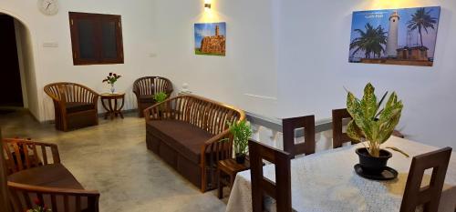 a living room with a couch and a table and chairs at Light House View Inn - Galle Fort in Galle