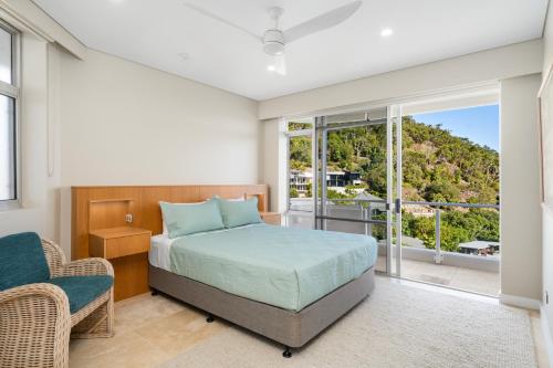 a bedroom with a bed and a large window at Luxury Hamilton Island Sub Penthouse on Level 12 & Buggy & Transfers in Hamilton Island