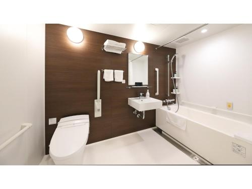 a bathroom with a toilet and a sink at Smile Hotel Kanazawa Nishiguchi Ekimae - Vacation STAY 11502v in Kanazawa