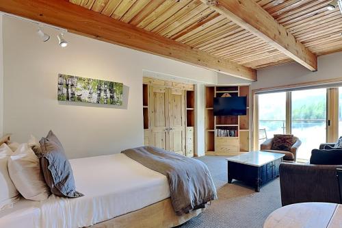 a bedroom with a bed and a living room at Timberline Condominiums Studio Deluxe Unit 217 in Snowmass Village