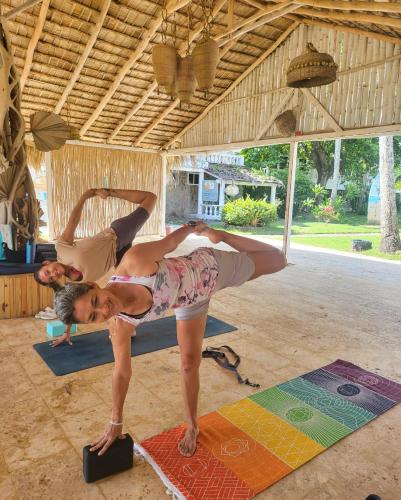 a woman and man doing yoga in a room at Beach Bungalow 100 m Playa Coson in Las Terrenas