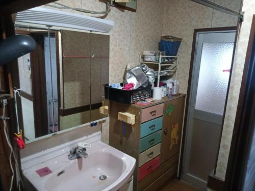 a bathroom with a sink and a mirror at Minshuku Yamachan - Vacation STAY 19921 in Takamatsu