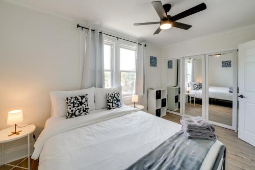 a white bedroom with a bed and a ceiling fan at 4 Mi to Dtwn Pet-Friendly Home in Pittsburgh in Beltzhoover