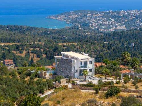 an aerial view of a villa on a hill with the ocean at Villa Grand Fysaeri in Vamos
