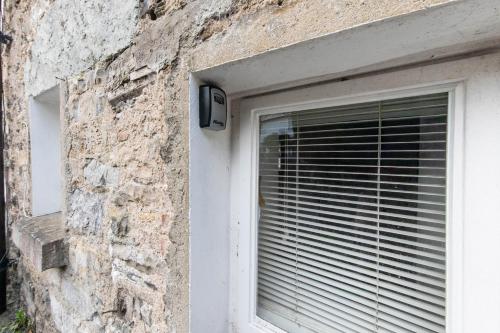 a window with blinds on the side of a building at Meadowcroft in Lindale