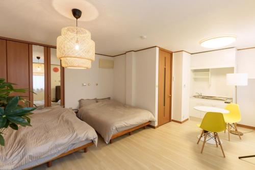 a bedroom with a bed and a desk and a table at Another Sky Nagoyaekimae - Vacation STAY 14782v in Nagoya