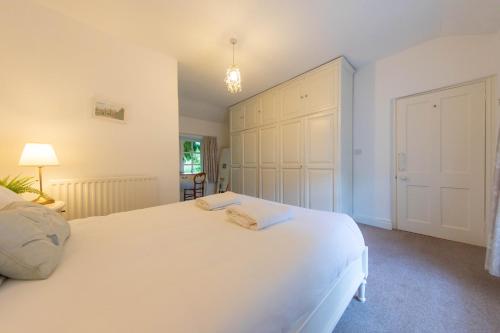 a bedroom with a large white bed and a closet at Meadowcroft in Lindale