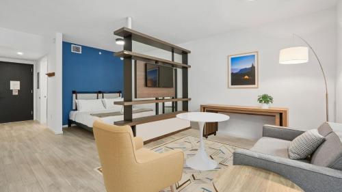 a living room with a couch and a bed at Sentral Alea Miami in Miami