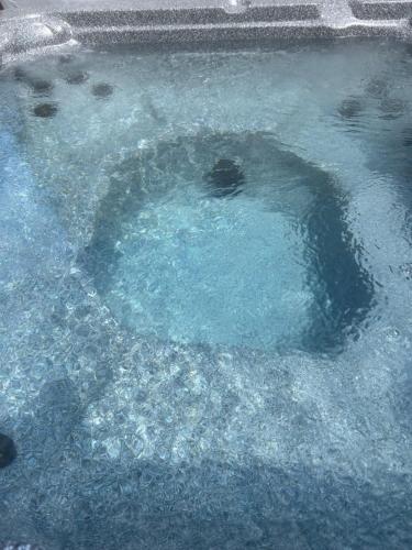 a pool of blue water with ice in it at Serenity Charm - Walk in Town, Shaw, Hottub in Niagara on the Lake