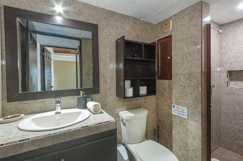 a bathroom with a sink and a toilet and a mirror at Colonial Beach Apartment and 5th Floor in Playa del Carmen