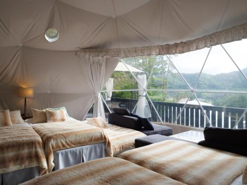 a room with four beds and a large window at TOCORO. Mt.Fuji CAMP & GLAMPING - Vacation STAY 23389v in Oishi