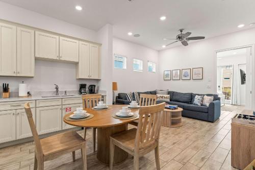 a kitchen and living room with a table and a couch at The Flamingo Nest - Kid Friendly in Orlando