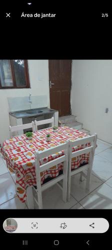 a table with a bed in a room at Casa Bela Vista in Blumenau