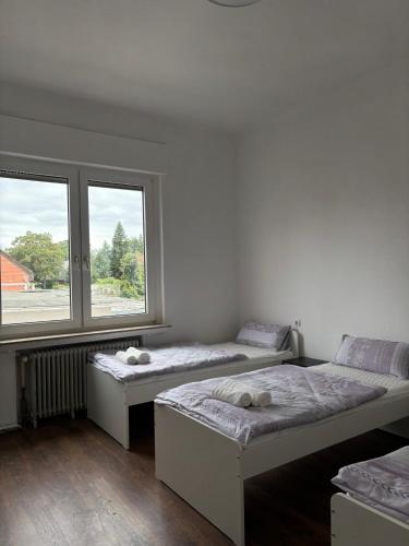 two beds in a room with a window at Apartment in Niederdorla
